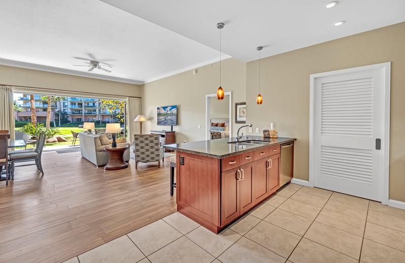 Open-concept layout connects kitchen to bright lanai and living area.