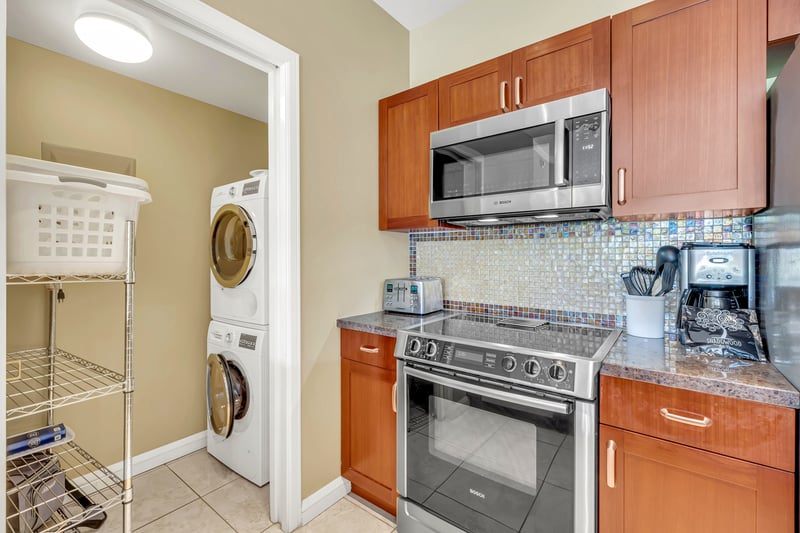Fully equipped kitchen with adjoining laundry room for added convenience.