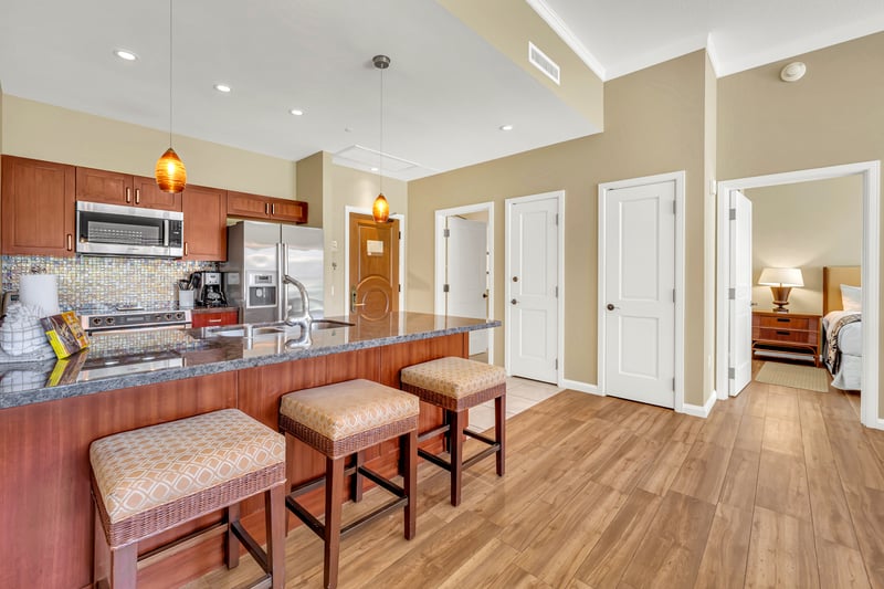 Stylish kitchen island with bar seating and bedroom access nearby.