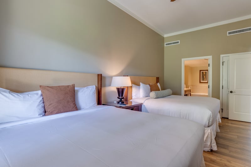 Inviting double beds with ensuite bath and soothing earth-tone walls.
