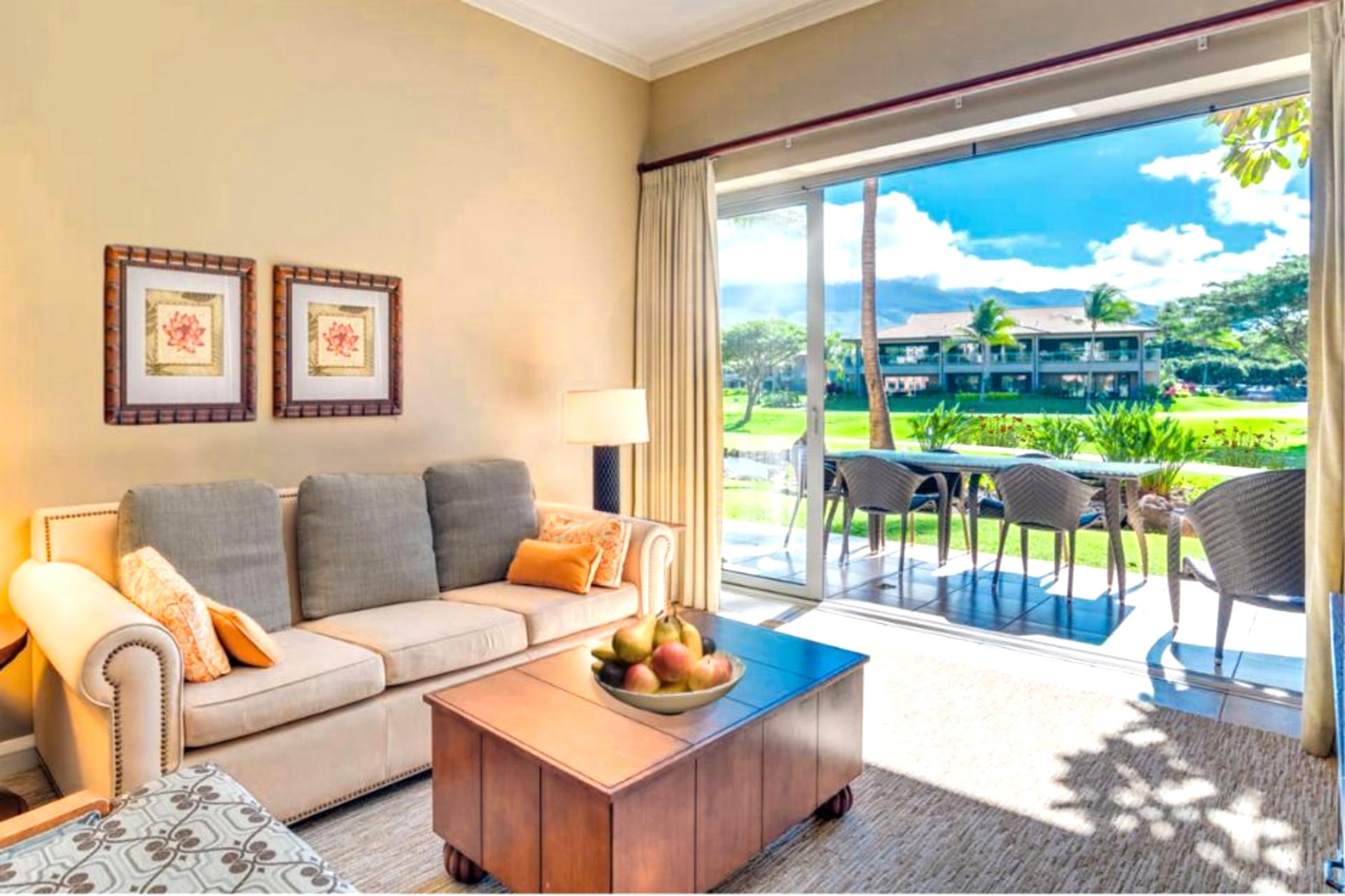 Bright living room with patio access and stunning garden view.