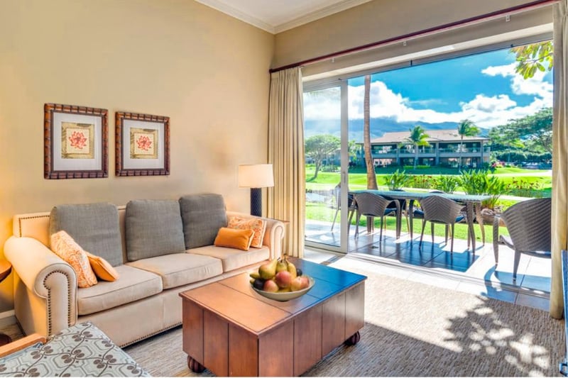 Bright living room with patio access and stunning garden view.