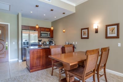 Warm kitchen and dining area with pendant lighting and decor.