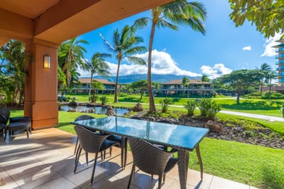 Outdoor dining with tropical garden, pond, and mountain view paradise.