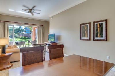 Open living space with TV, garden views, and dining table.