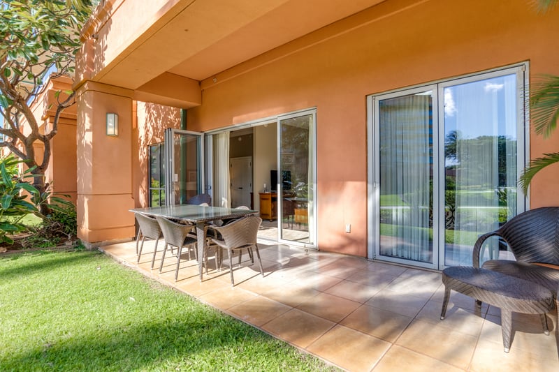 Private patio with sliding doors, outdoor dining, and garden serenity. HKK-108