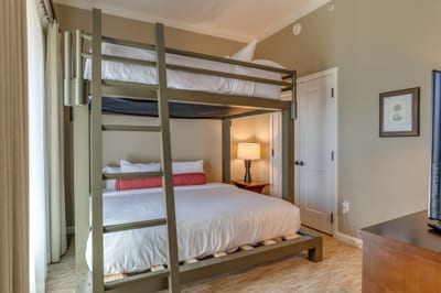 Bunk bedroom blends cozy comfort, warm lighting, and modern design.
