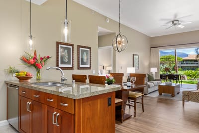 Bright gourmet kitchen opens to tropical views and cozy living space.