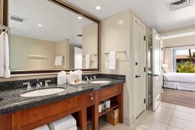 Spacious ensuite bath with double vanity and serene garden view access.