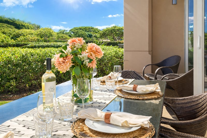 Start your morning with coffee at your outdoor table, surrounded by tropical greenery and partial ocean views.