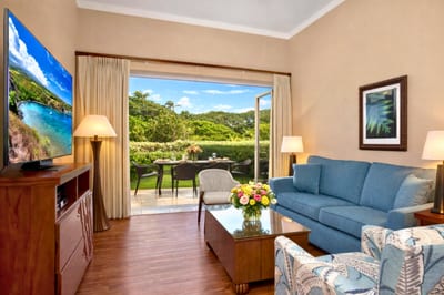 Your living room welcomes you with a plush sofa, large flat screen TV, and sliding doors opening to the lanai.