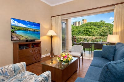 Settle into your comfortable seating area and enjoy garden views just steps from your private outdoor space.