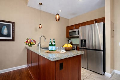 Prepare island inspired meals in your kitchen featuring granite counters and stainless steel appliances.