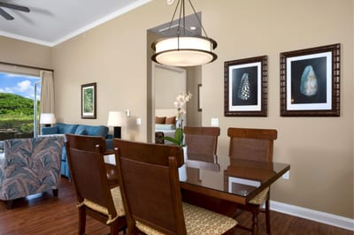 Gather around your dining table beneath modern lighting, with your kitchen and living area seamlessly connected.