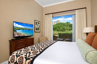 Retreat to your Primary Bedroom with a King bed, tropical artwork, and direct access to your lanai.