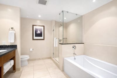 Unwind in your soaking tub or rinse off in the separate glass shower after a day in the sun.