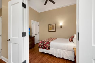 Your guest bedroom features a Queen bed, warm island decor, and convenient access to the hall bathroom. The dresser drawers and closet give your guests plenty of space to spread out.
