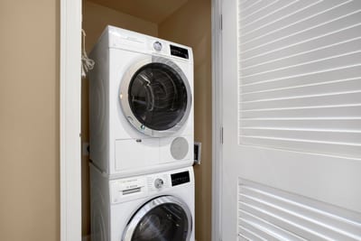 Enjoy the convenience of your in unit Bosch washer and dryer tucked neatly behind closet doors.