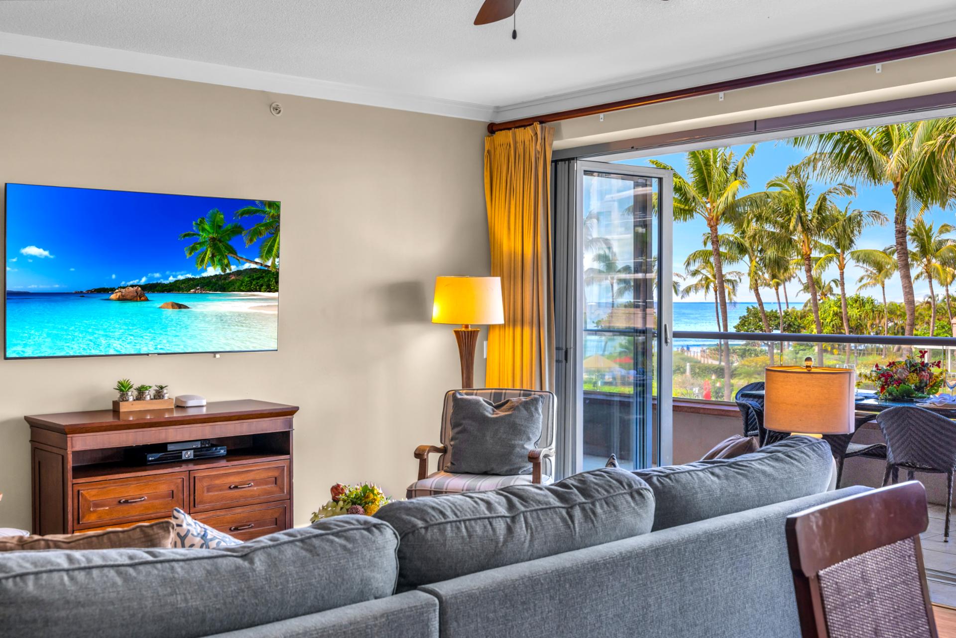 Relax in a bright living room with tropical scenery just outside