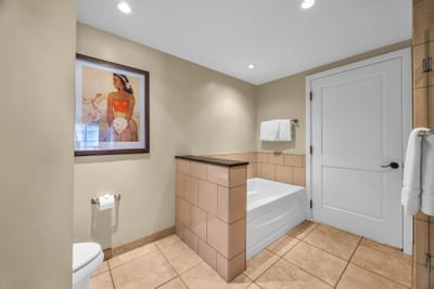 The guest bath features a separate glass shower and bath tub, perfect for unwinding after a day of exploring Maui
