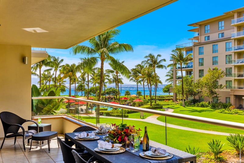 Shaded lanai seating invites reading, snacking, and cool trade-wind breaks between pool sessions