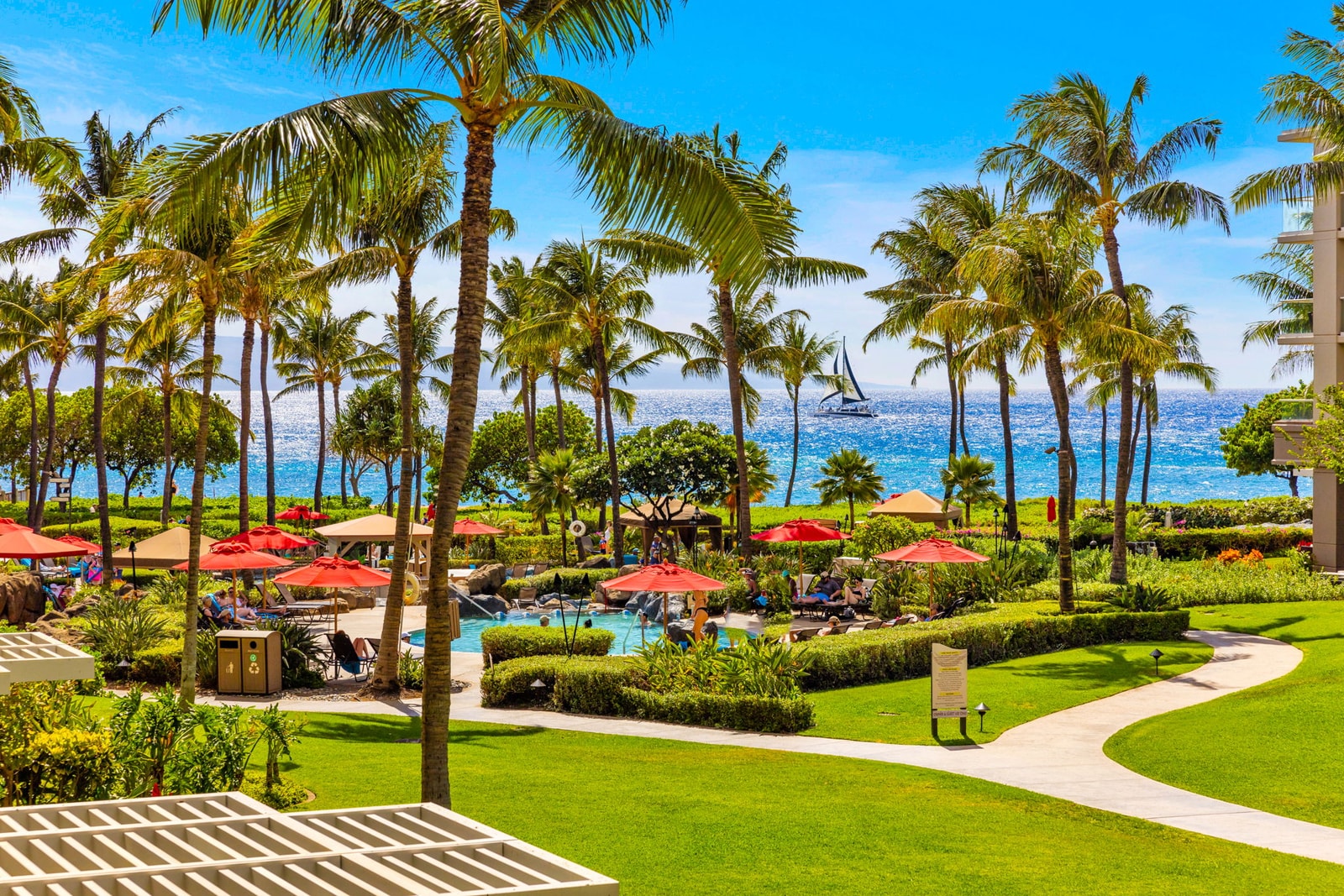 Palm-lined gardens and a sparkling ocean peek set the scene for your Kaanapali Maui vacation rental mornings 