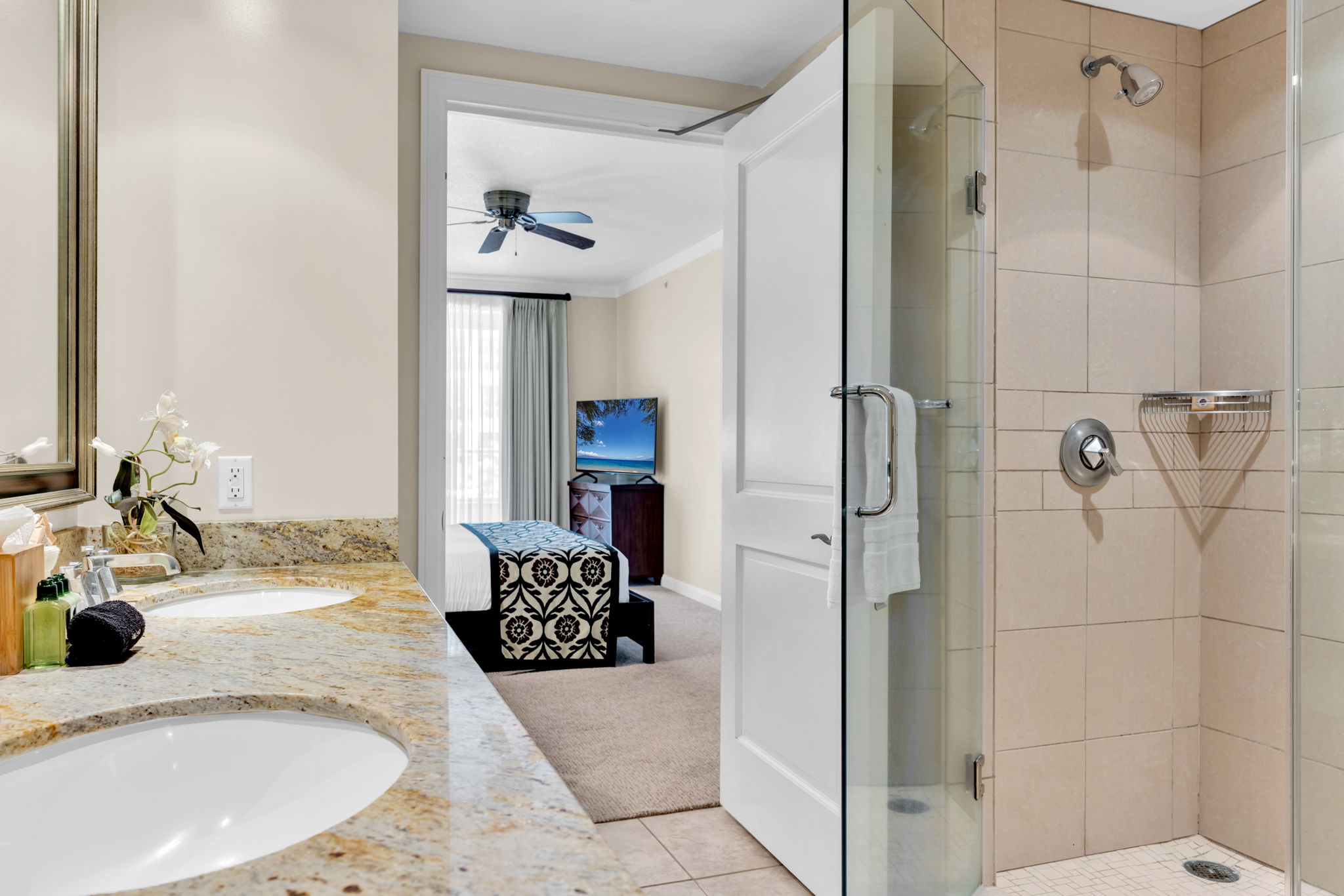 Spa inspired bathroom with dual vanities, walk i shower, and soaking tub welcomes post-beach unwinding 