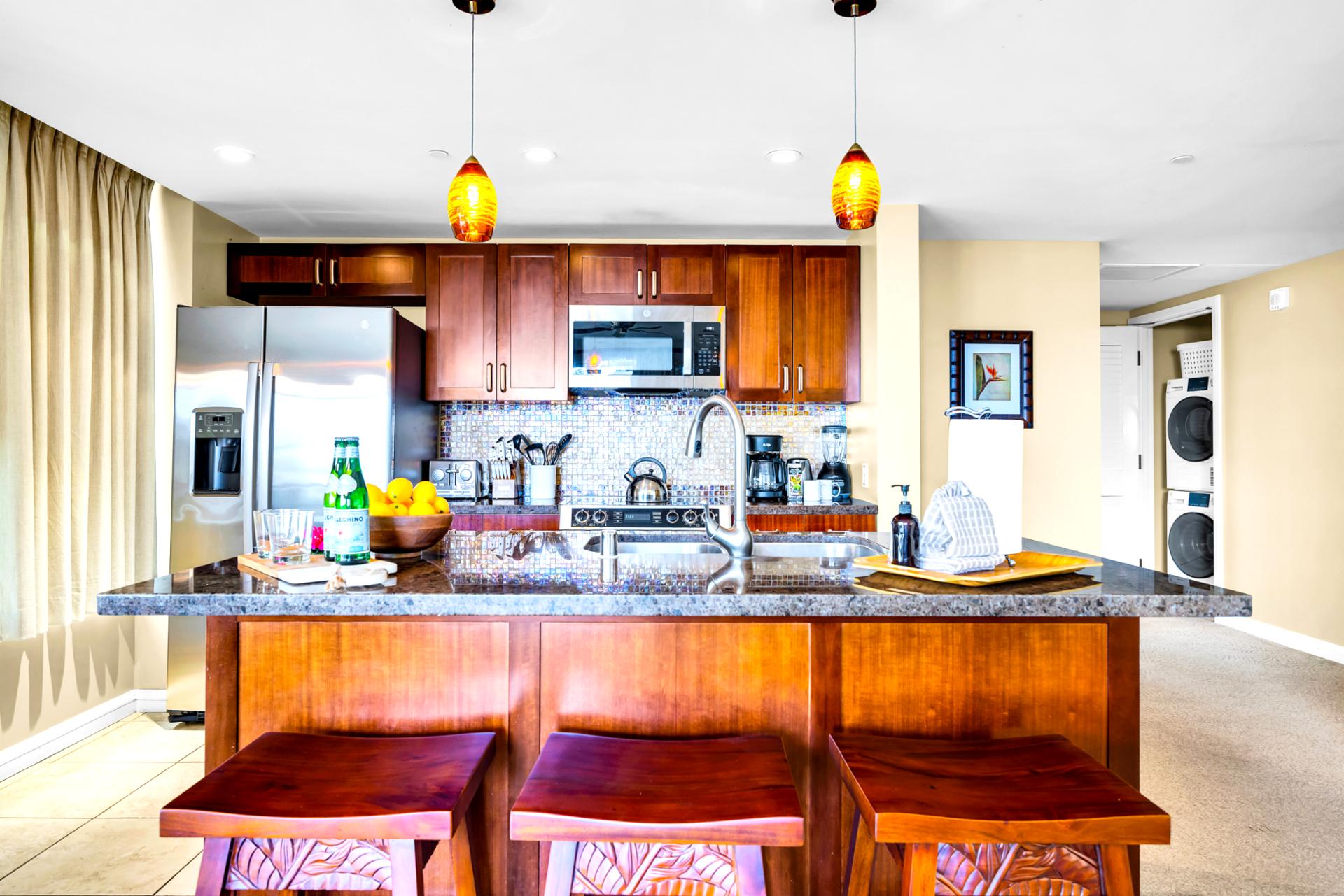 Gather around the kitchen island with bar seating and pendant lighting, a natural hub for breakfasts and happy hour bites.