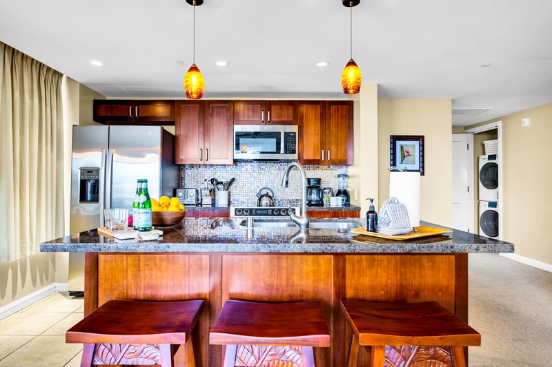 Gather around the kitchen island with bar seating and pendant lighting, a natural hub for breakfasts and happy hour bites.