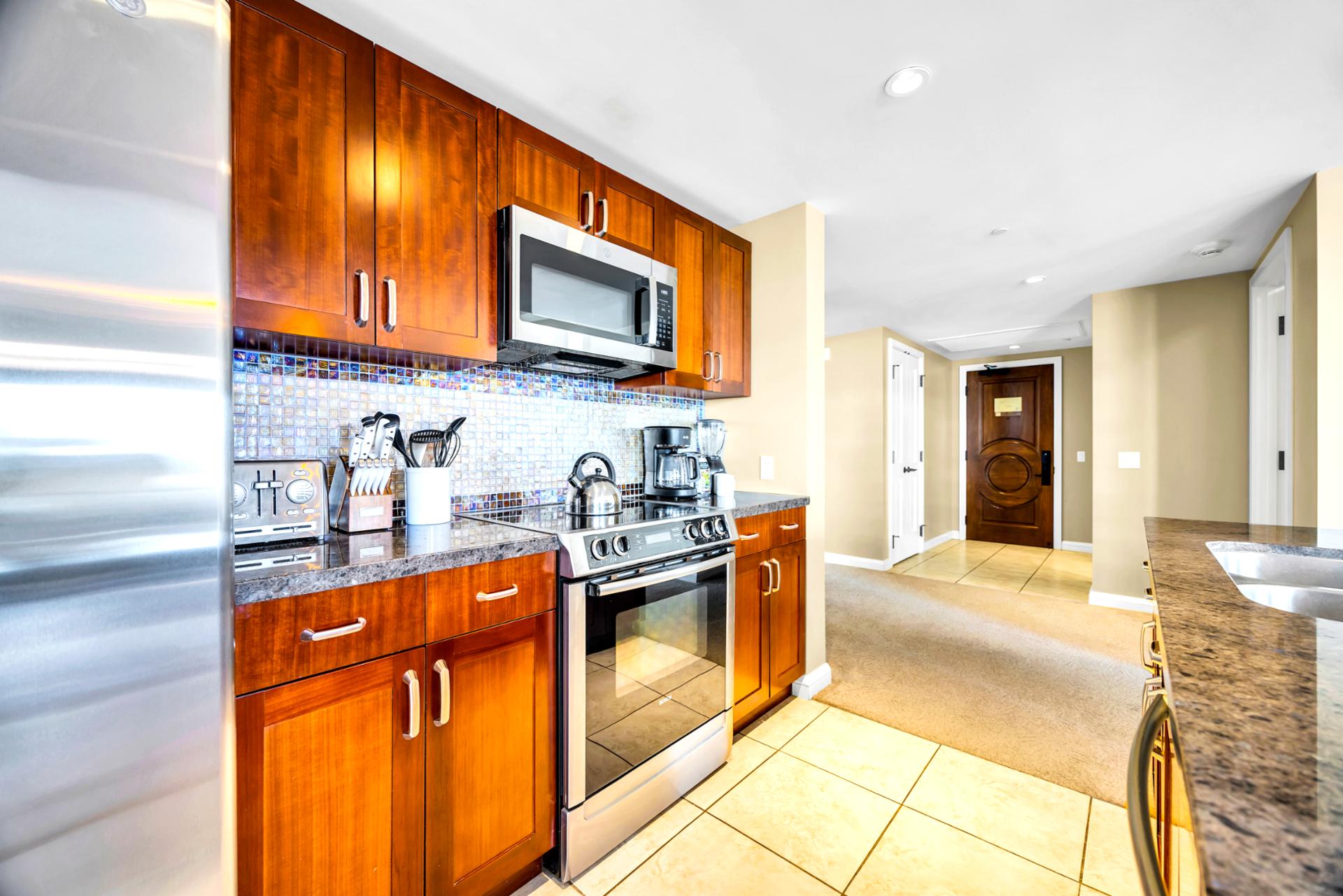 Stock the spacious kitchen and enjoy warm wood cabinetry, giving you plenty of storage for groceries and beach day treats.