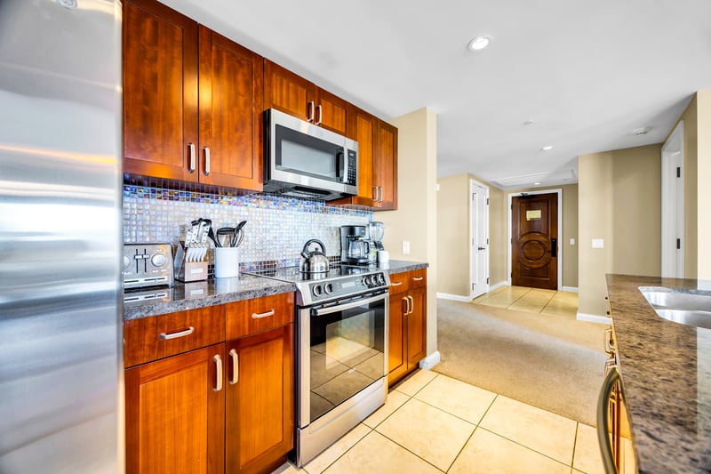 Stock the spacious kitchen and enjoy warm wood cabinetry, giving you plenty of storage for groceries and beach day treats.