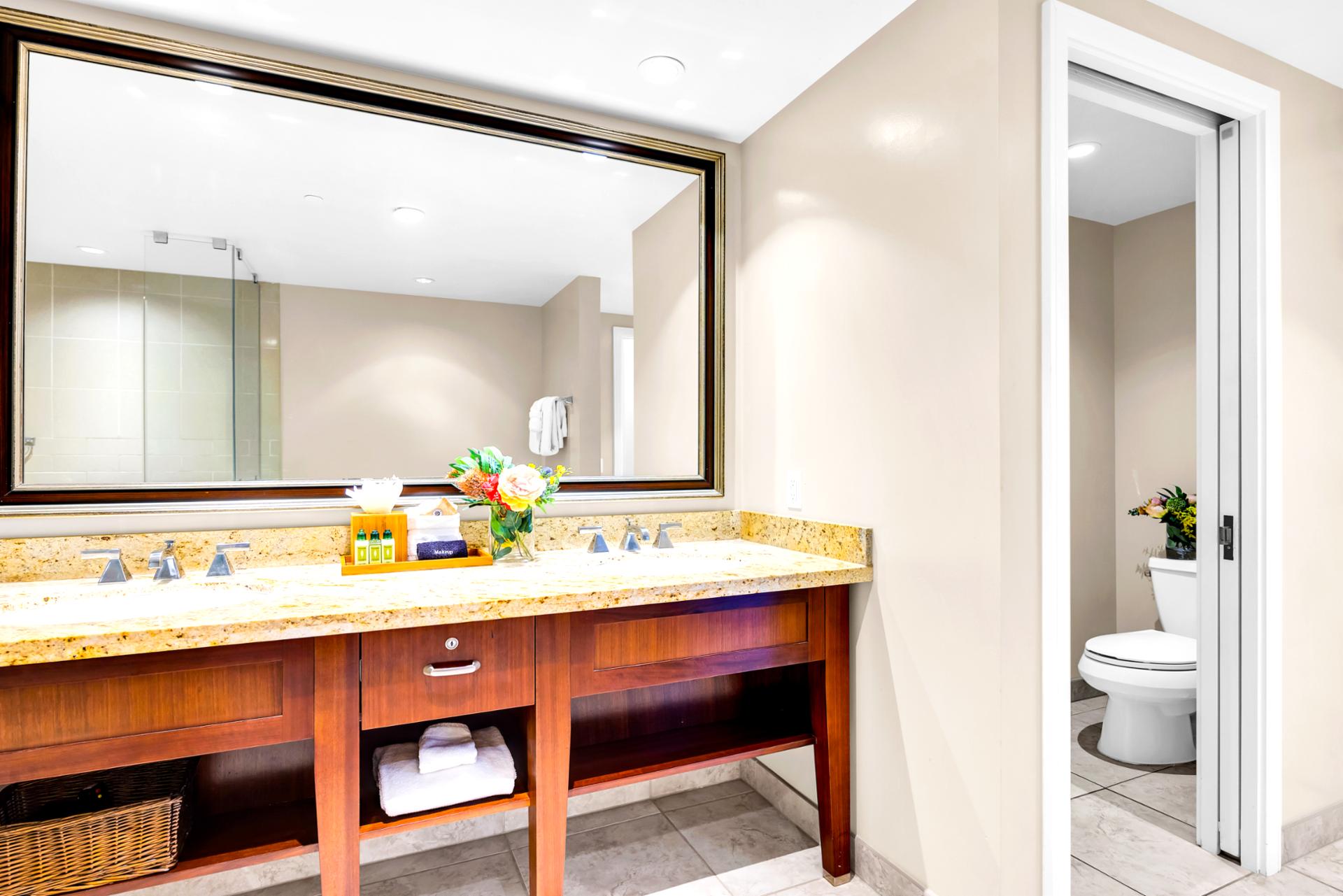 Refresh at the primary bath vanity with ample counter space and mirrors, giving you room to spread out and get ready.