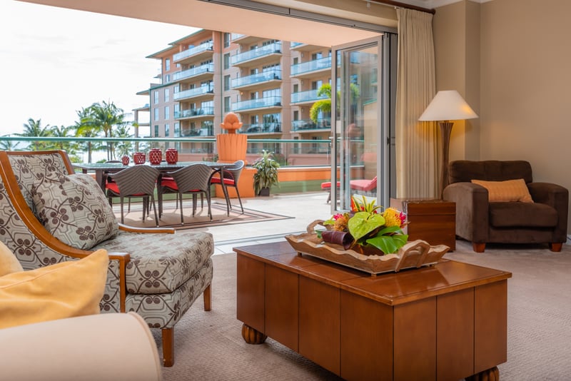 Open-concept living flows to lanai with tropical ocean views. HKK-225