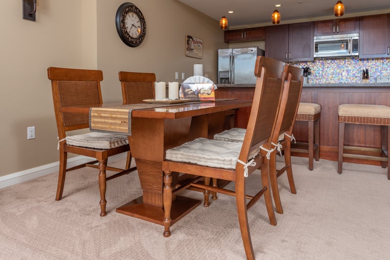 Elegant dining space with cushioned chairs, island decor, and gourmet kitchen. HKK-225