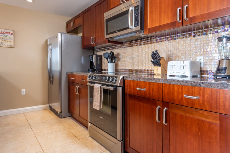 Fully equipped kitchen with modern appliances and elegant wood cabinetry. HKK-225