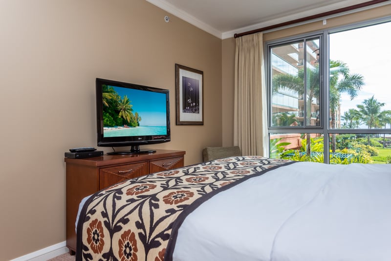 Tropical bedroom retreat with TV, garden view, and natural light. HKK-225