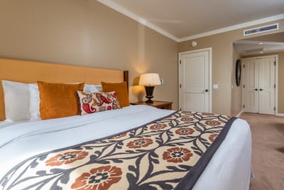Cozy king bedroom with warm tones, plush bedding, and style. HKK-225