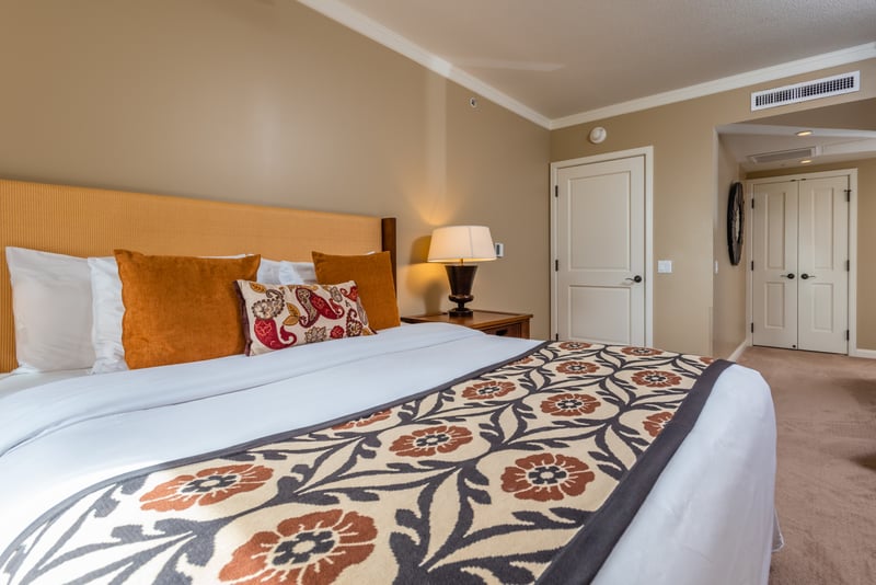 Cozy king bedroom with warm tones, plush bedding, and style. HKK-225