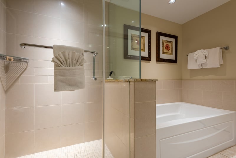 Elegant bathroom with walk-in shower, soaking tub, and decorative towels. HKK-225
