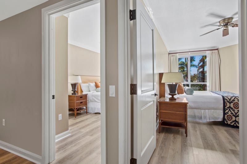 Two serene bedrooms with palm views and inviting island elegance.