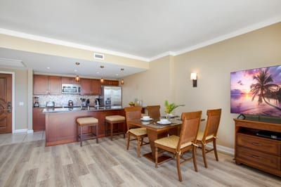 Modern kitchen and dining blend comfort, style, and island charm.