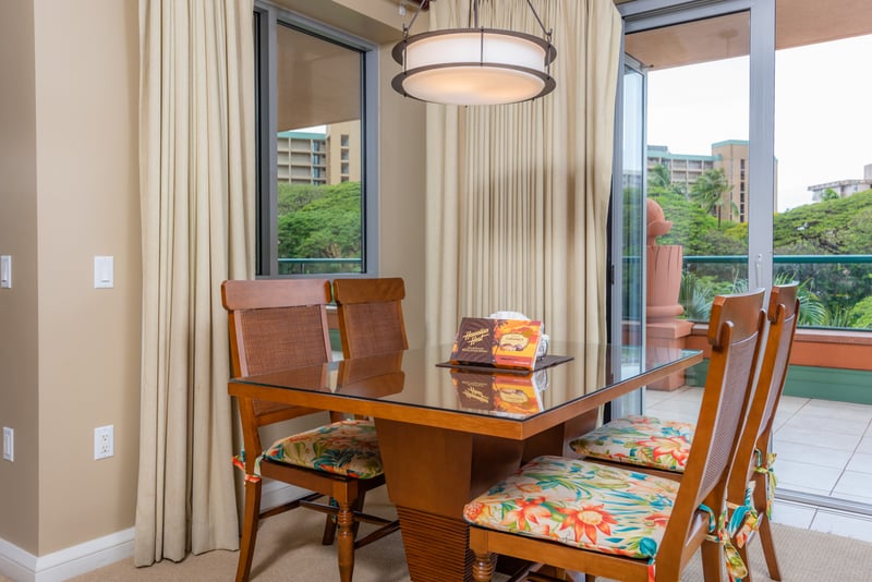 Tropical-themed dining area with lanai access and garden views