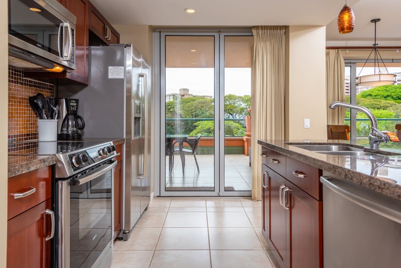 Modern kitchen with stainless appliances and direct access to lanai