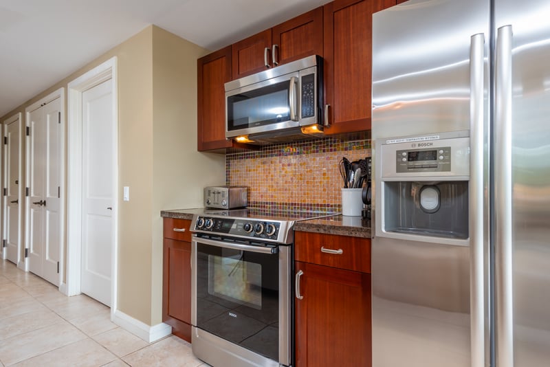 Stylish kitchen with stainless appliances and colorful mosaic tile backsplash