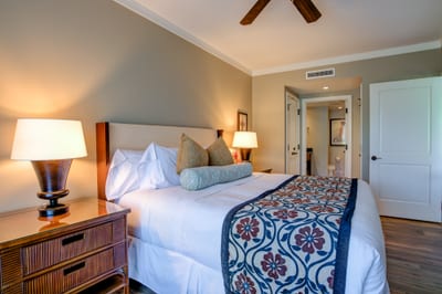 Inviting king suite with plush bedding and warm, ambient lighting.