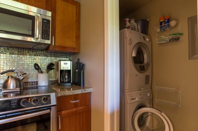 Compact kitchen with modern appliances and in-unit washer-dryer convenience.