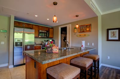 Chic island kitchen with granite countertops and cozy breakfast bar.