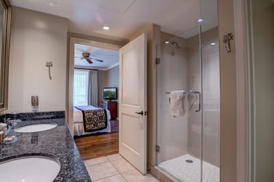 Spacious ensuite with granite counters and glass walk-in shower luxury.