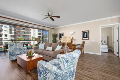 Bright coastal living room with tropical charm and garden-view lanai access.