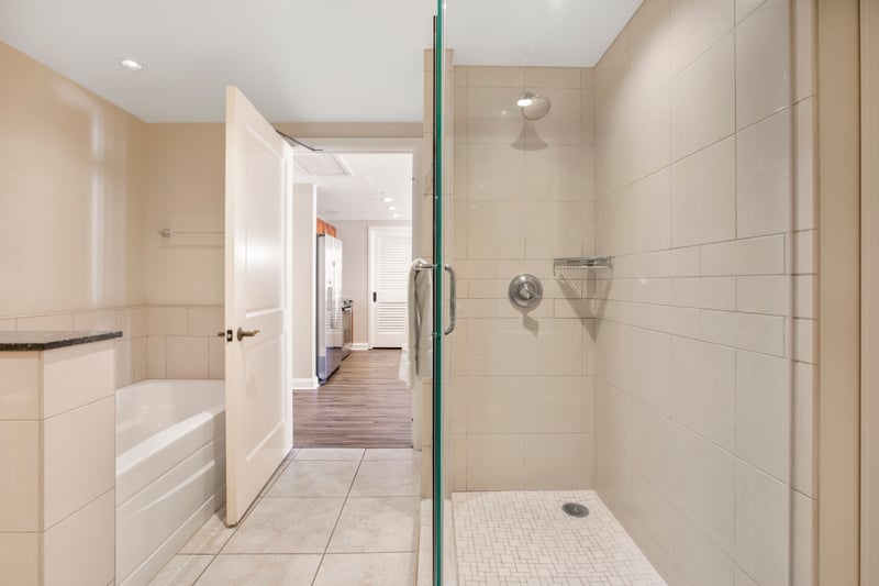 Modern bathroom with walk-in shower and relaxing soaking tub nearby.